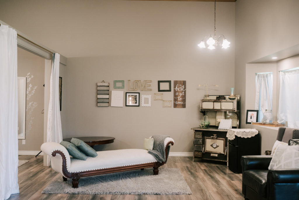 Bridal suite featuring white antique chaise, plenty of light and lots of space.