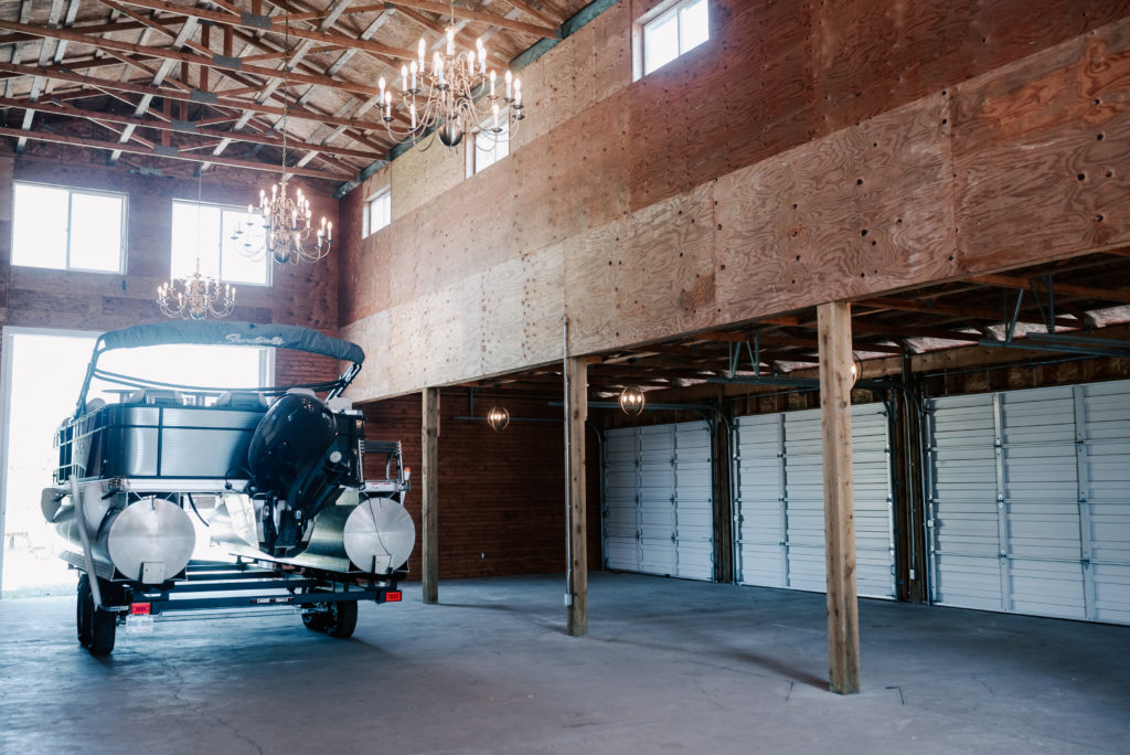 The property boat stored in the barn when not in use, with a view of the wraparound garage doors to the side